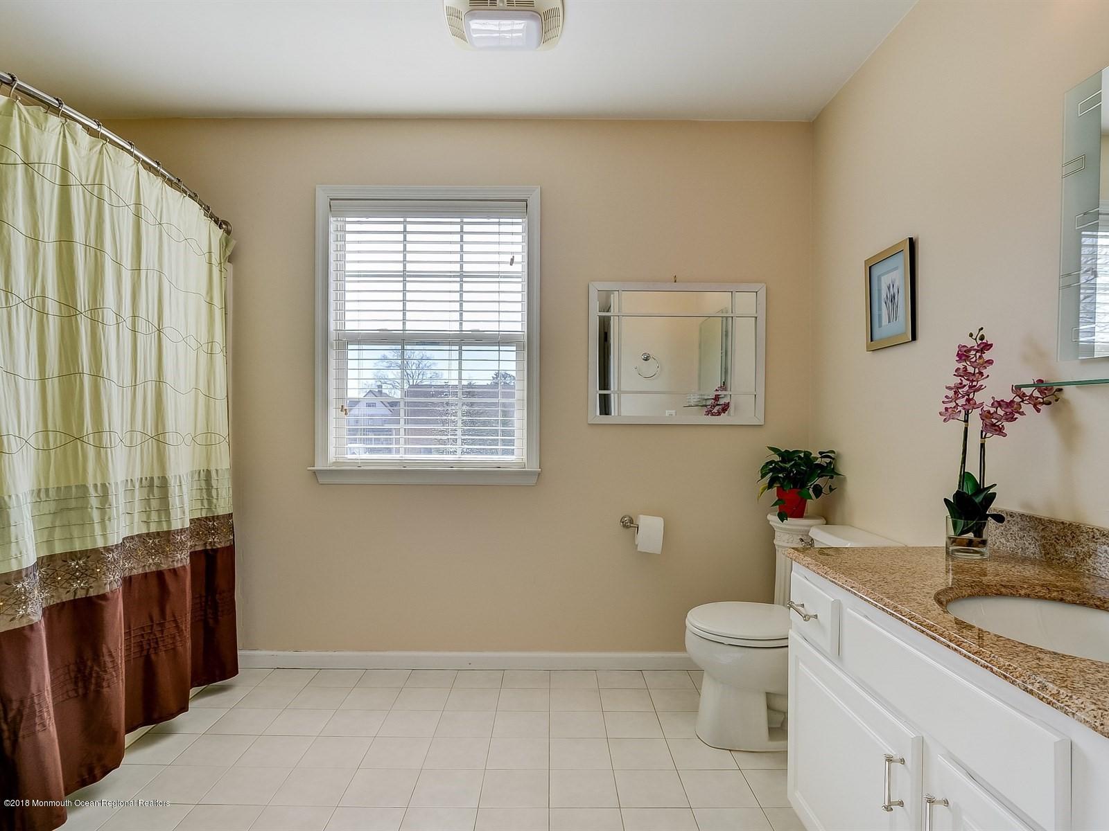 13 Hamilton Road Englishtown, NJ 07726 - Photo 18 of 24 a bathroom with a granite countertop sink a toilet and a mirror