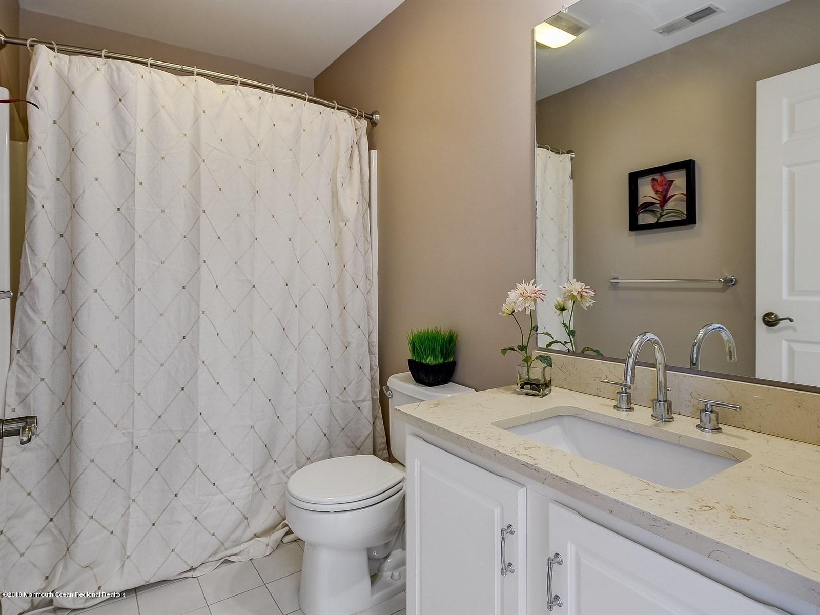 13 Hamilton Road Englishtown, NJ 07726 - Photo 21 of 24 a bathroom with a granite countertop sink and a mirror