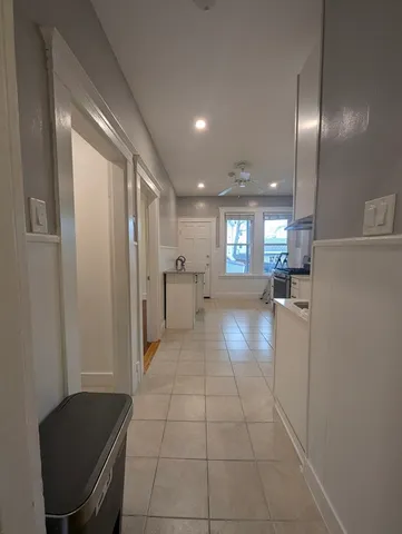a view of a hallway with furniture and a livingroom