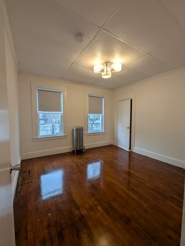 a view of a livingroom with hardwood floor and chandelier