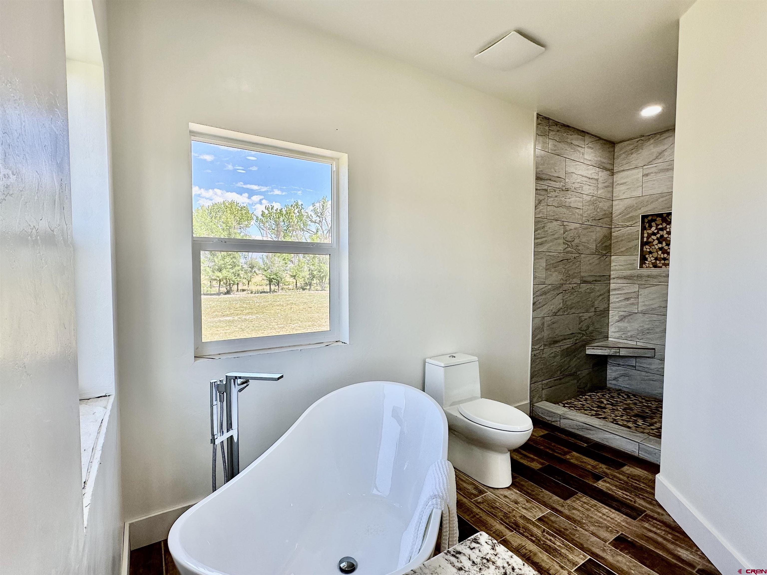 18755 H Road Delta, CO 81416 - Photo 11 of 26 a bathroom with a toilet a sink and shower
