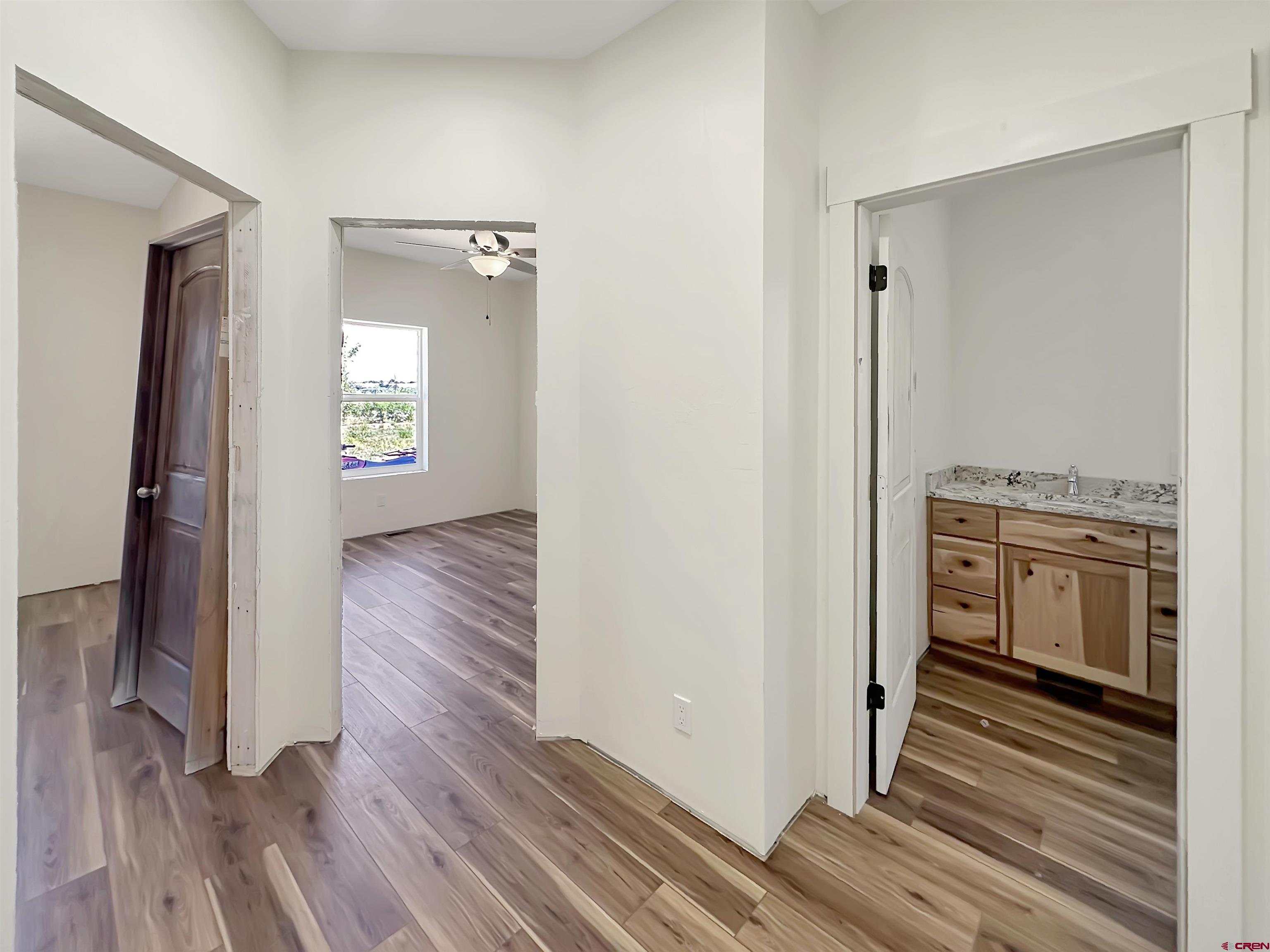 18755 H Road Delta, CO 81416 - Photo 13 of 26 a view of a hallway with wooden floor and cabinets