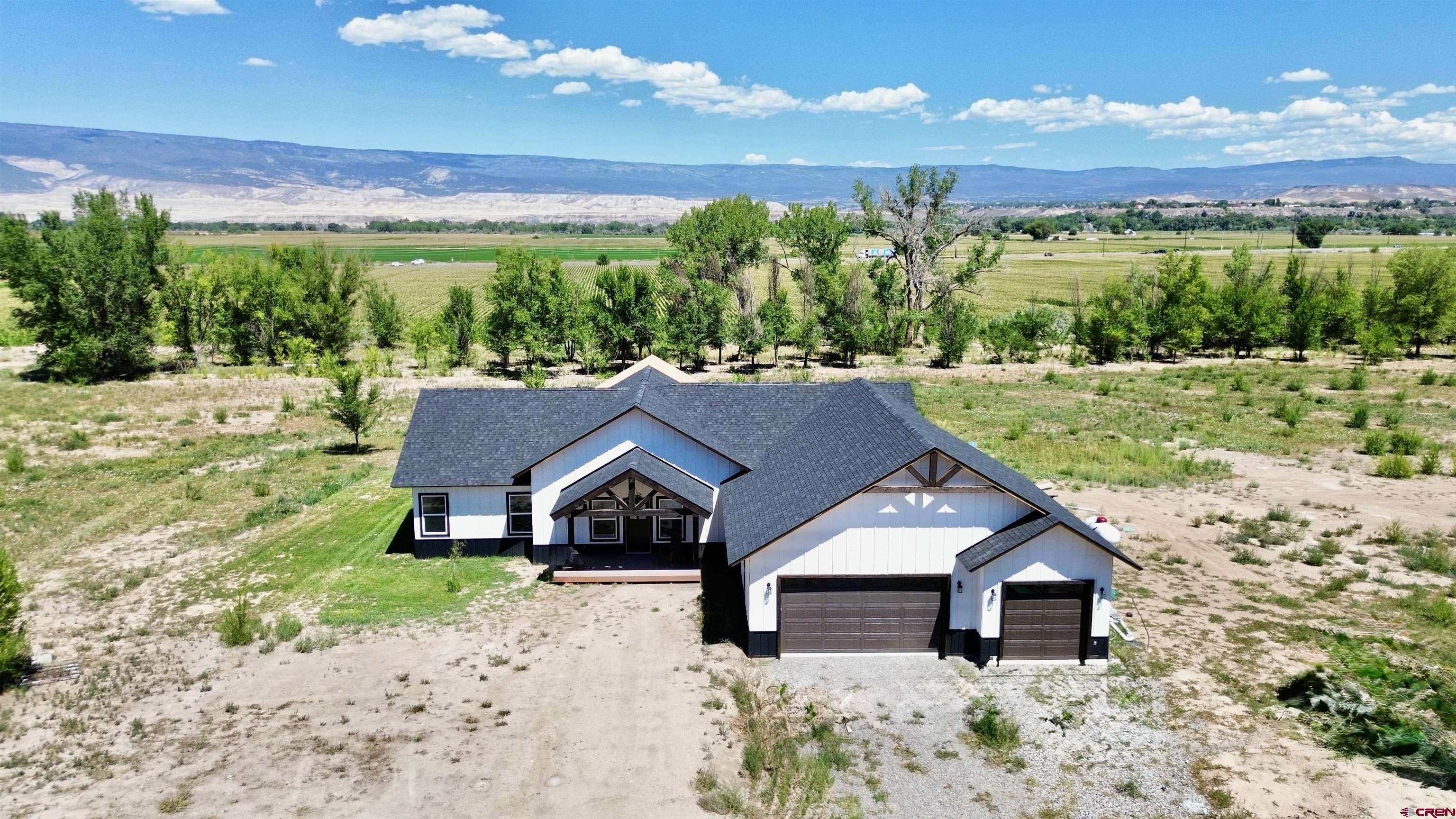 18755 H Road Delta, CO 81416 - Photo 23 of 26 a house with green field in front of it
