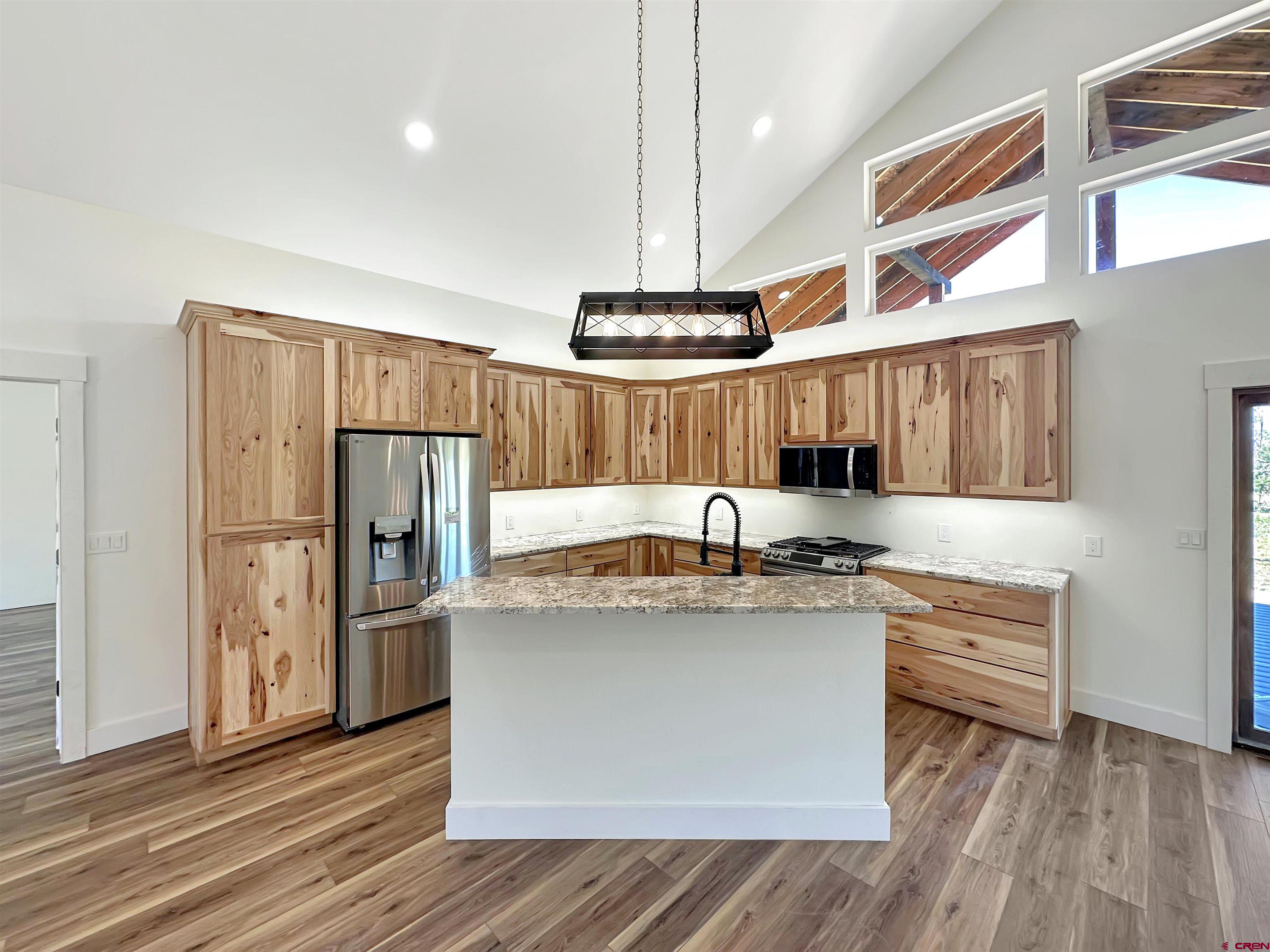 18755 H Road Delta, CO 81416 - Photo 7 of 26 a kitchen with stainless steel appliances granite countertop a sink a stove and a refrigerator