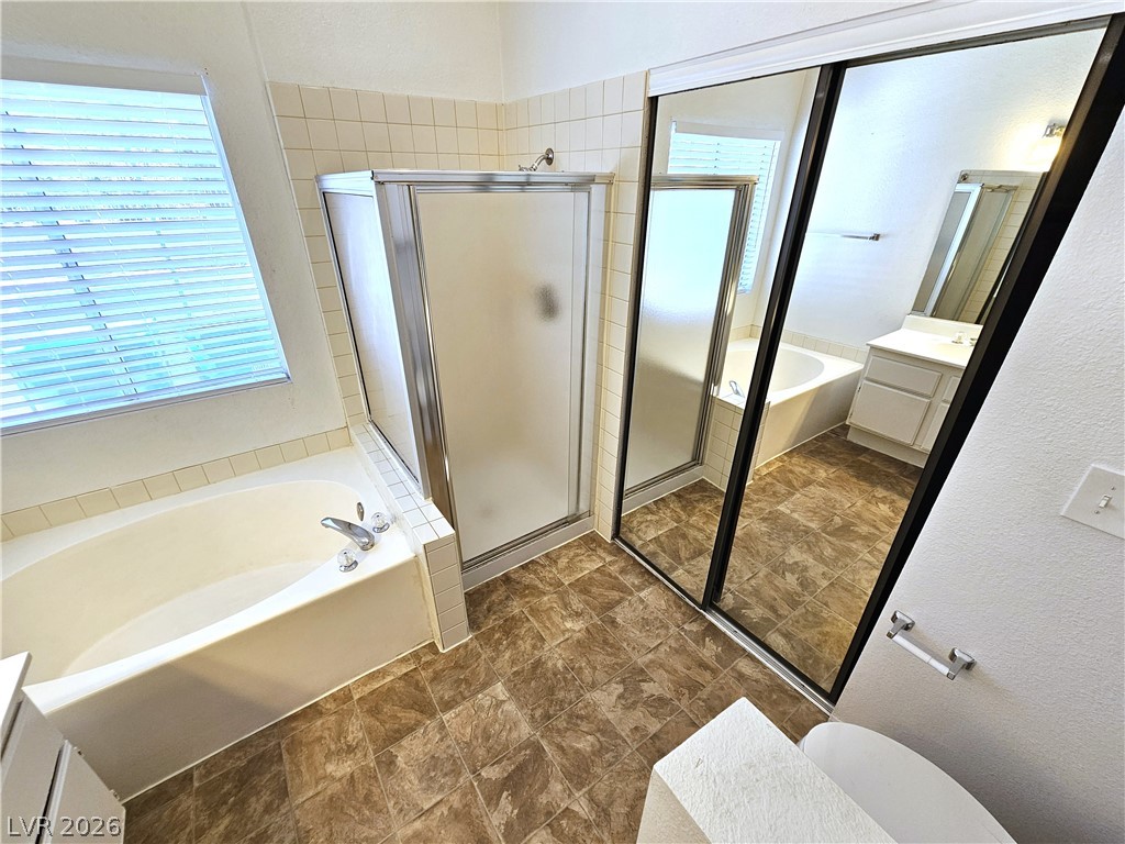 2817 Albemarle Way Henderson, NV 89014 - Photo 17 of 25 A windowed bathing sanctuary with a large tub and walk-in shower.