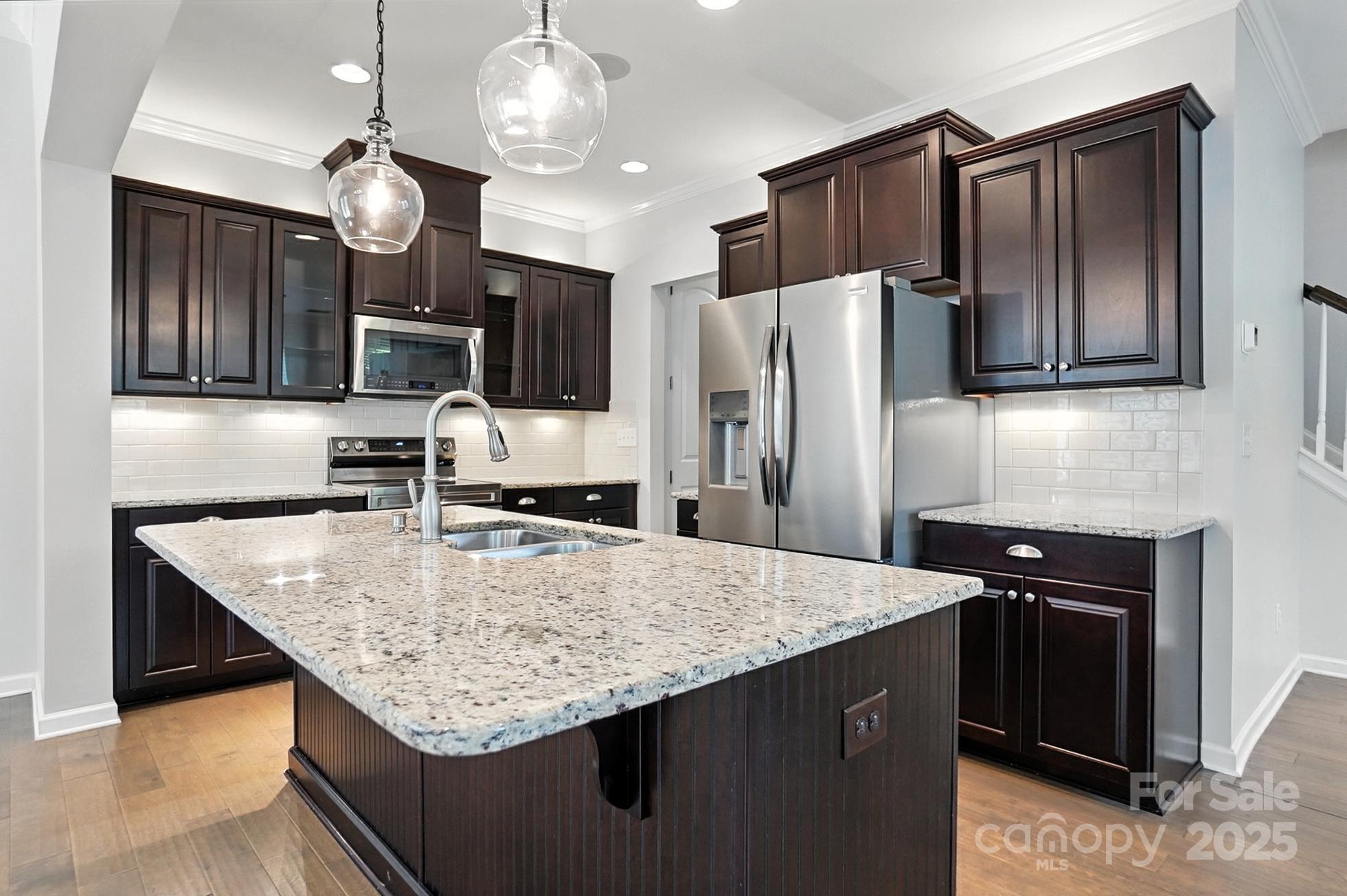 809 Ayrshire Avenue Fort Mill, SC 29708 - Photo 16 of 48 a kitchen with stainless steel appliances granite countertop a sink refrigerator and microwave