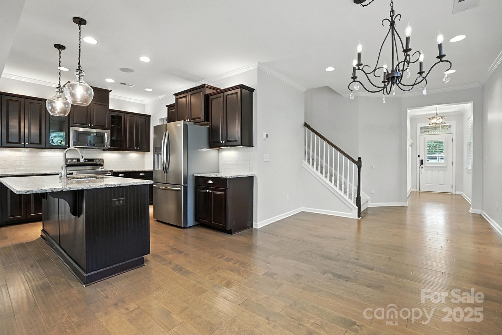 809 Ayrshire Avenue Fort Mill, SC 29708 - Photo 20 of 48 a kitchen with stainless steel appliances granite countertop a stove a refrigerator a kitchen island a sink and a chandelier