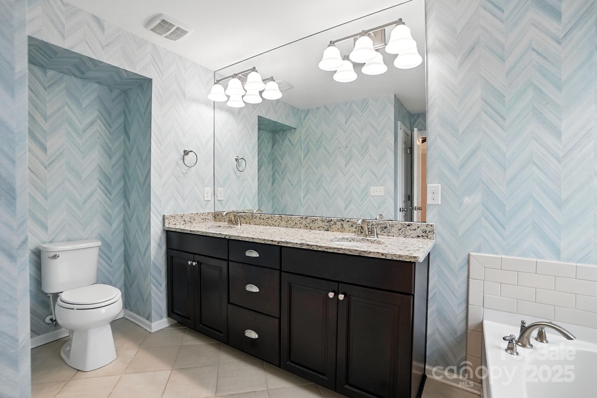 809 Ayrshire Avenue Fort Mill, SC 29708 - Photo 32 of 48 a bathroom with a toilet sink and mirror