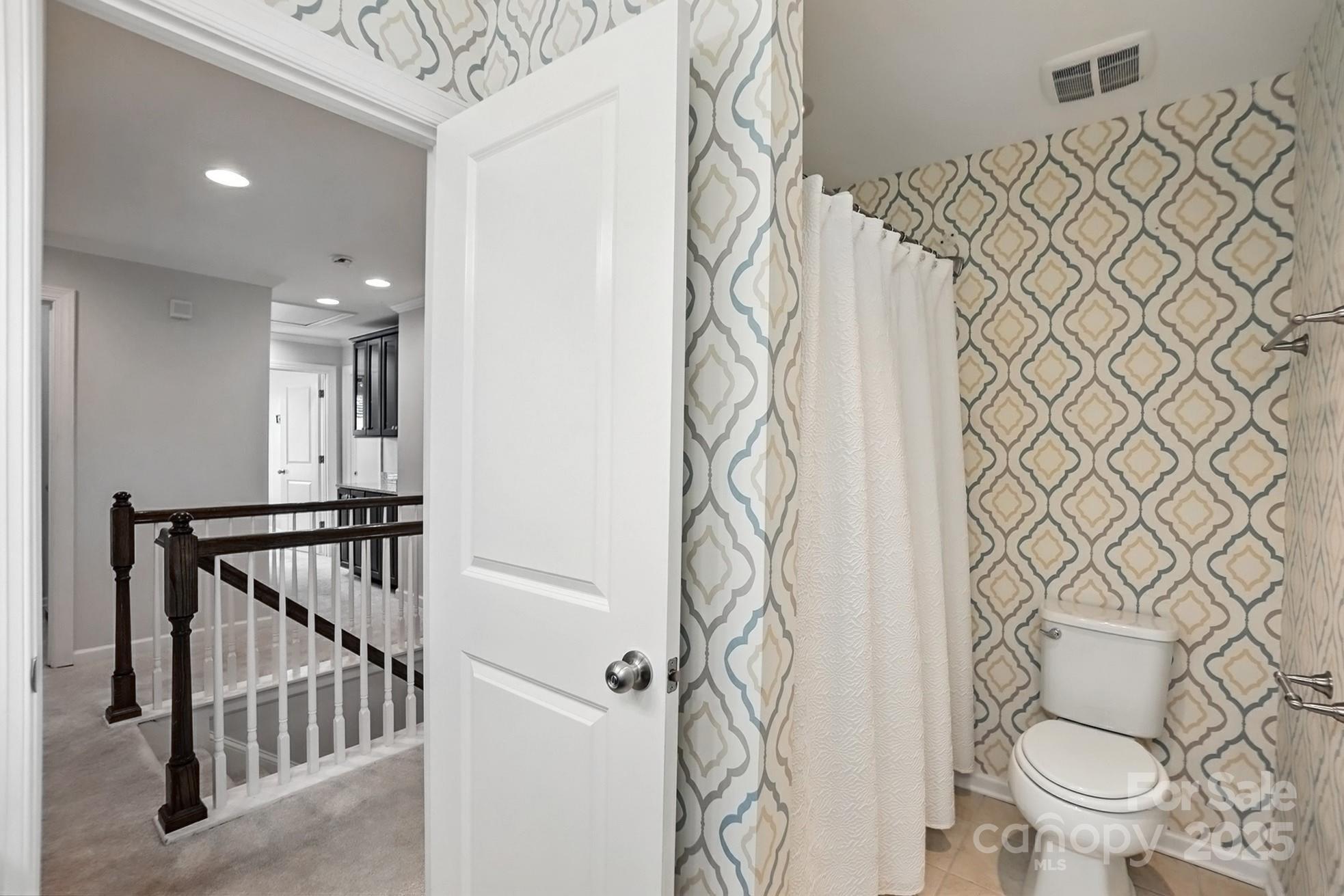 809 Ayrshire Avenue Fort Mill, SC 29708 - Photo 37 of 48 a bathroom with a toilet and shower curtain