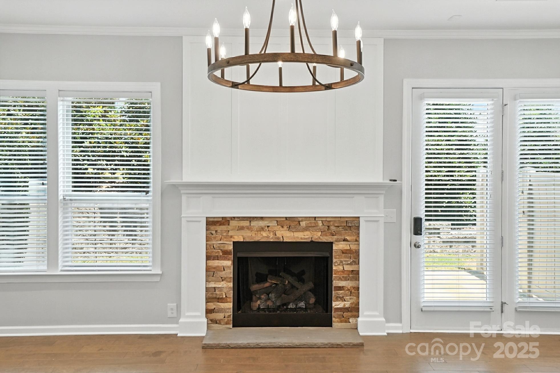 809 Ayrshire Avenue Fort Mill, SC 29708 - Photo 9 of 48 a living room with a fireplace and windows