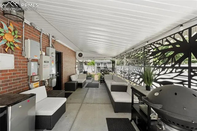 a view of a house with backyard tub and sitting area