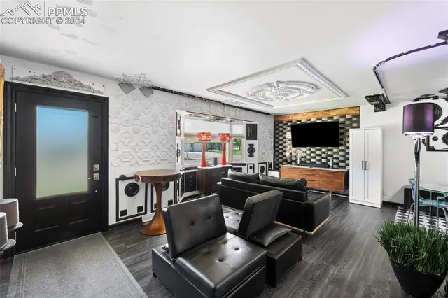 a living room with furniture a flat screen tv and a fireplace