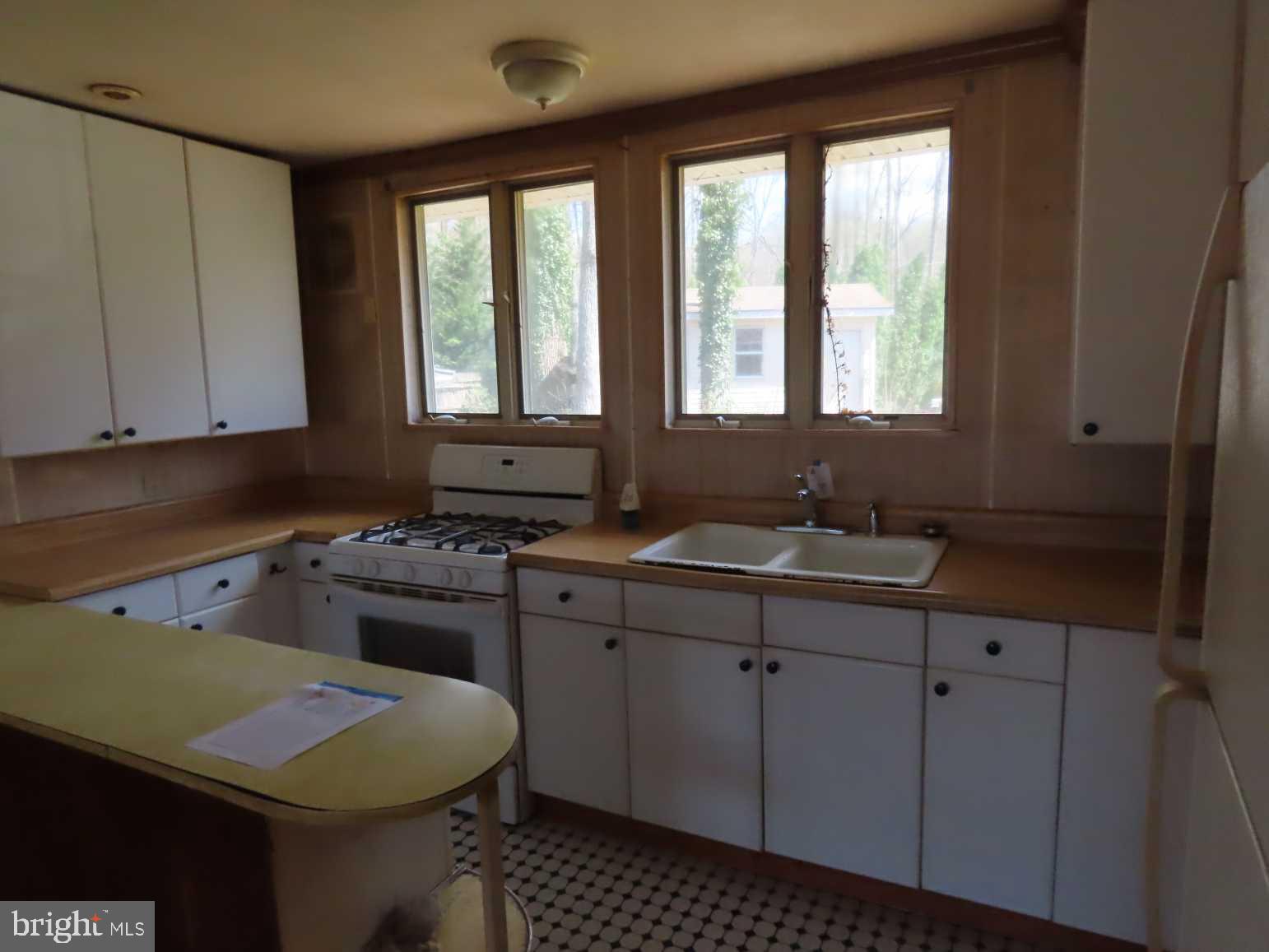 75 Elkside Road Elkton, MD 21921 - Photo 6 of 10 a kitchen with a sink stove and cabinets