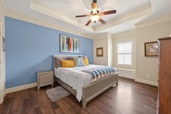 a spacious bedroom with a bed and a chandelier