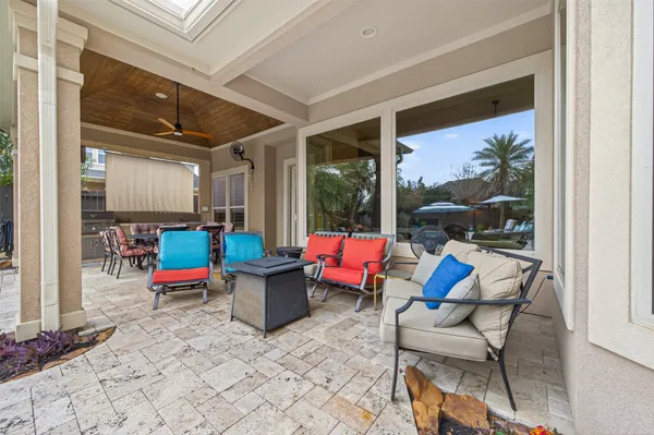 a view of a swimming pool with a lounge chair and potted plants