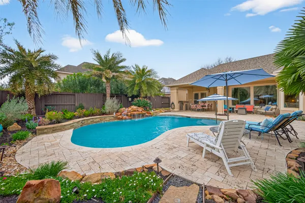 a view of a house with swimming pool and porch