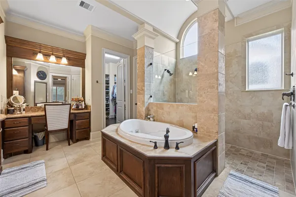 a bathroom with a tub a sink and a mirror