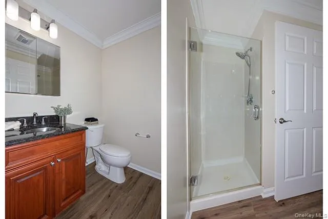 a bathroom with a granite countertop toilet a sink and shower