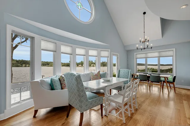 a dining room with furniture window and wooden floor