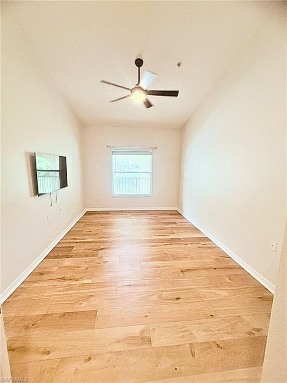 21301 Lancaster Run, Unit 822 Estero, FL 33928 - Photo 3 of 20 a view of empty room with wooden floor and fan
