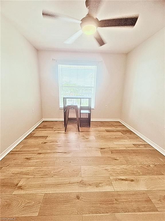 21301 Lancaster Run, Unit 822 Estero, FL 33928 - Photo 7 of 20 a view of wooden floor and a chandelier fan in a room