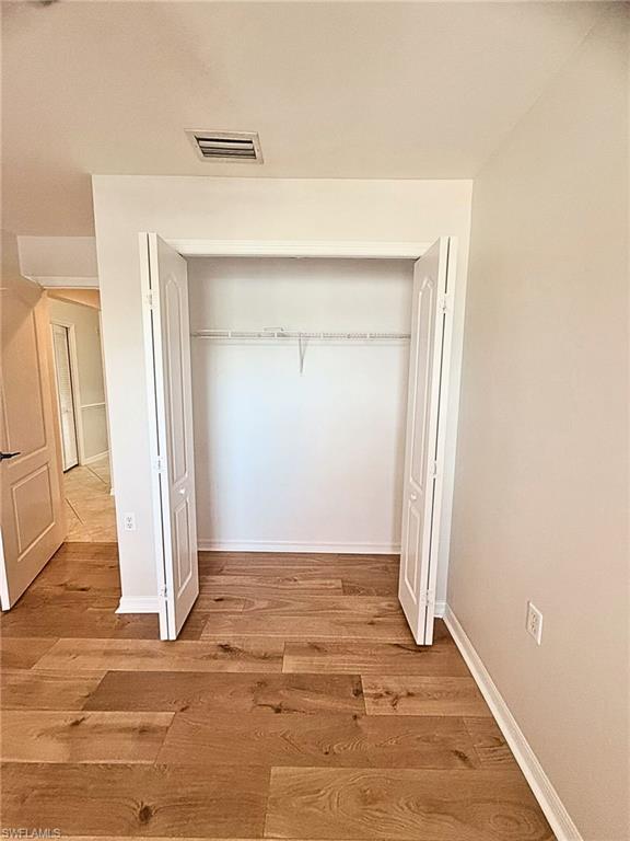 21301 Lancaster Run, Unit 822 Estero, FL 33928 - Photo 8 of 20 an empty room with wooden door and door