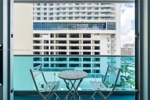 a view of a chair and table in the balcony