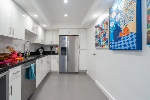 a kitchen with stainless steel appliances a refrigerator and a stove top oven