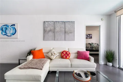 a living room with furniture and a potted plant