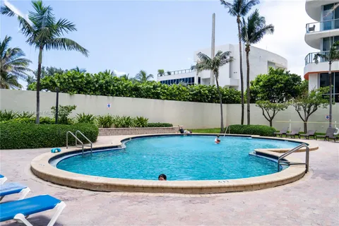 a view of a swimming pool with a yard