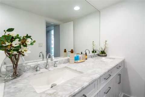 a bathroom with a double vanity sink and a mirror