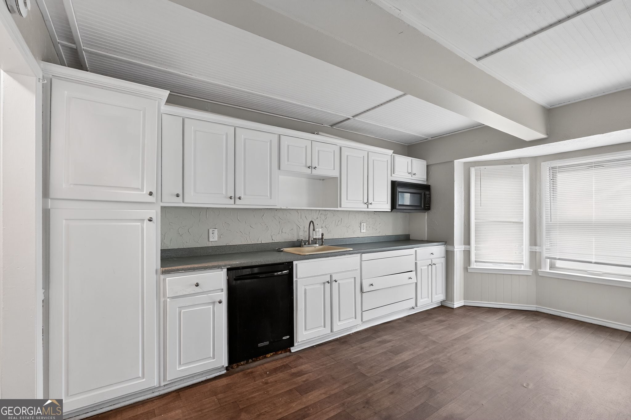 3285 Old Salem Road Southeast Conyers, GA 30013 - Photo 23 of 33 a kitchen with granite countertop white cabinets and white appliances