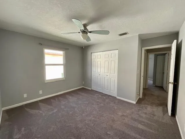 an empty room with a empty space and a ceiling fan
