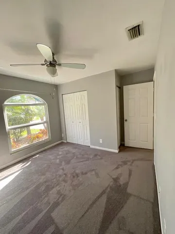 a kitchen with granite countertop a refrigerator and a stove top oven