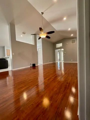 a view of a room with wooden floor