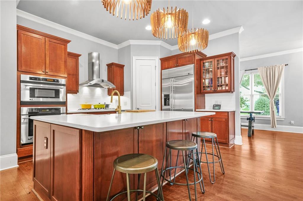 385 15th Street Northwest, Unit 6 Atlanta, GA 30363 - Photo 12 of 49 a kitchen with a table chairs sink and wooden floor