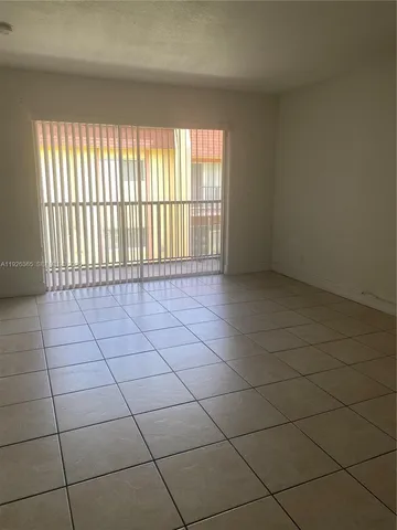 a view of an empty room and a window
