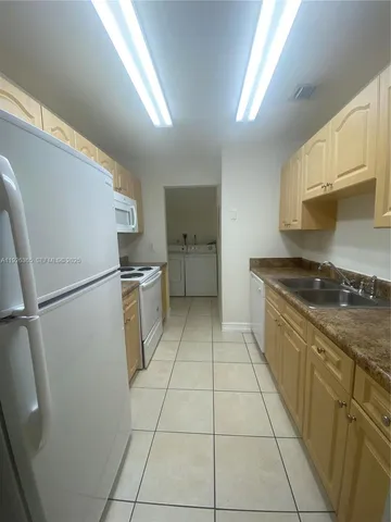 a kitchen with a cabinets and a stove top oven