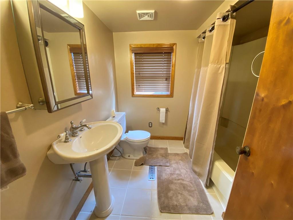 491 Mercer Road Greenville, PA 16125 - Photo 15 of 25 a bathroom with a sink and mirror with bathtub