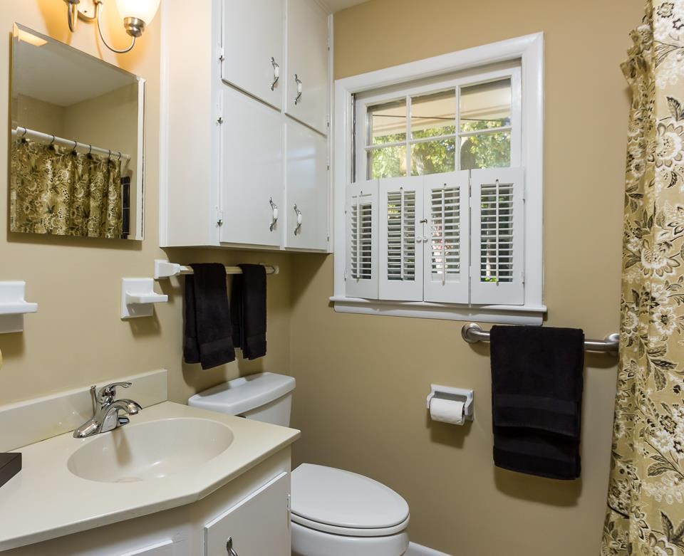 303 West Cornwall Road Cary, NC 27511 - Photo 11 of 22 a bathroom with a sink a toilet and a window
