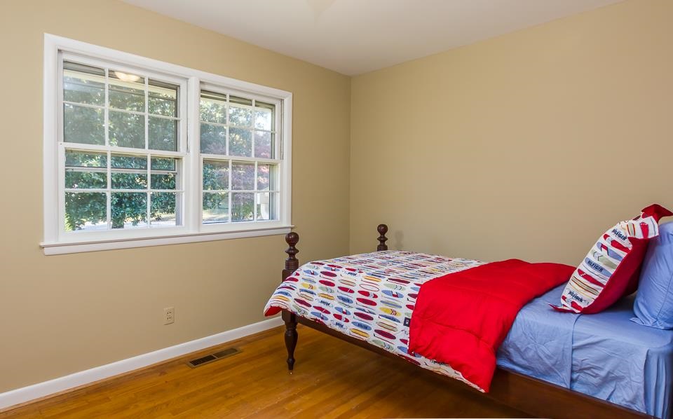 303 West Cornwall Road Cary, NC 27511 - Photo 12 of 22 a bedroom with a bed and a window