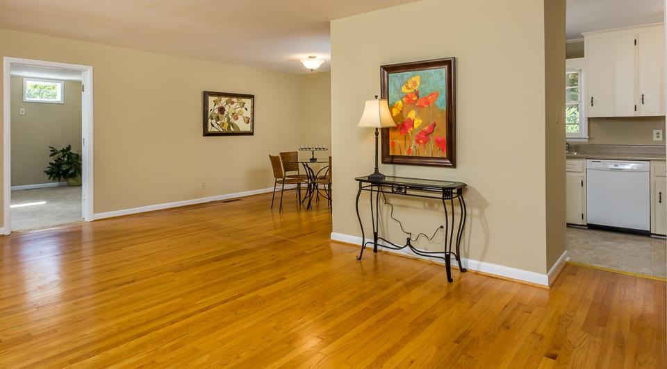303 West Cornwall Road Cary, NC 27511 - Photo 2 of 22 a view of an empty room with wooden floor and a chair