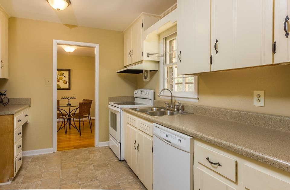 303 West Cornwall Road Cary, NC 27511 - Photo 4 of 22 a kitchen with a sink and cabinets