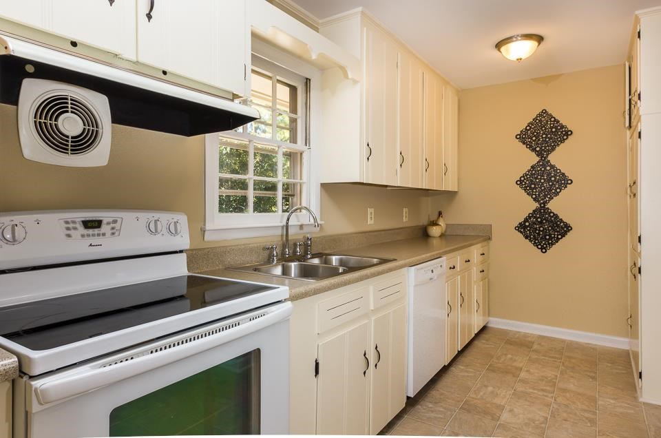 303 West Cornwall Road Cary, NC 27511 - Photo 5 of 22 a kitchen with stainless steel appliances granite countertop a sink and a stove