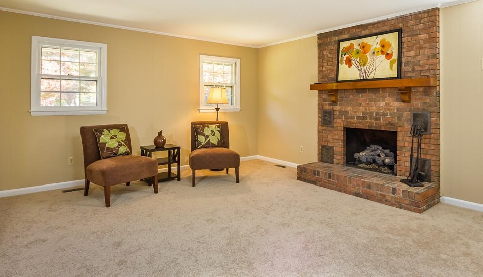 303 West Cornwall Road Cary, NC 27511 - Photo 6 of 22 a living room with furniture and a fireplace