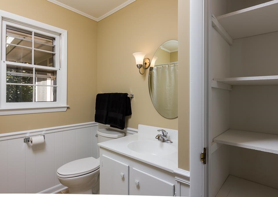 303 West Cornwall Road Cary, NC 27511 - Photo 8 of 22 a bathroom with a sink a toilet and a mirror