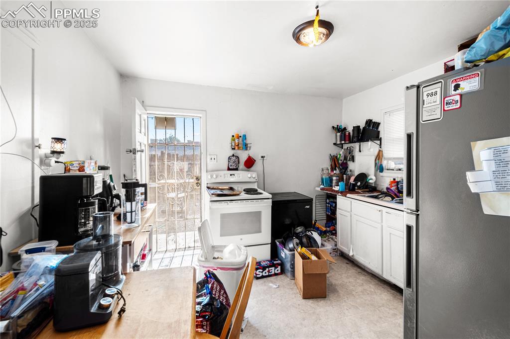1246 Rio Grande Avenue Pueblo, CO 81006 - Photo 4 of 11 a view of a workspace with furniture and a window