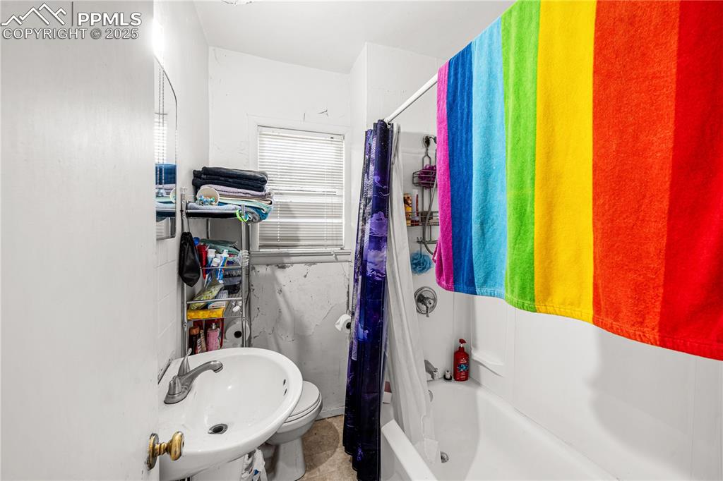 1246 Rio Grande Avenue Pueblo, CO 81006 - Photo 6 of 11 a bathroom with a bathtub sink and a shower