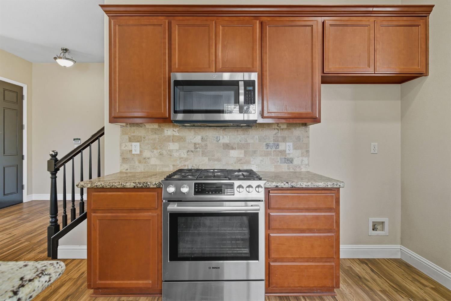 433 Travertine Drive Ripon, CA 95366 - Photo 11 of 38 a kitchen with granite countertop wood cabinets and stainless steel appliances