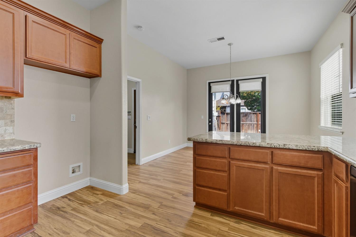 433 Travertine Drive Ripon, CA 95366 - Photo 14 of 38 a room view with wooden floor and window